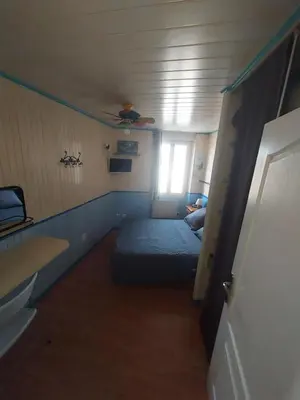 a small room with a bed and a window at ALBASUD - Appartement meublé avec terrasse - Salses le Chateau 66 in Salses-le-Chateau