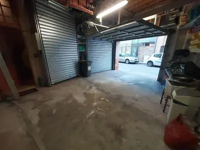 an empty garage with a door and a parking lot at ALBASUD - Appartement meublé avec terrasse - Salses le Chateau 66 in Salses-le-Chateau