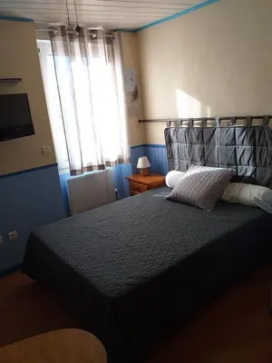 a bedroom with a bed and a window at ALBASUD - Appartement meublé avec terrasse - Salses le Chateau 66 in Salses-le-Chateau