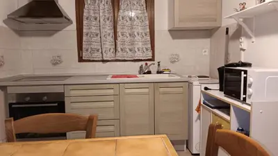 a small kitchen with a sink and a microwave at Gîte la Lanterne transition écologique avec borne de recharge 7kw Site sous vidéo protection in Nalzen