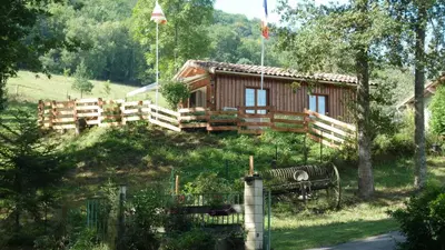 a log cabin with a bench in front of it at Gîte la Lanterne transition écologique avec borne de recharge 7kw Site sous vidéo protection in Nalzen