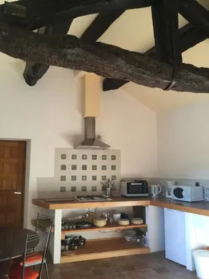 a kitchen with a counter with a stove top oven at Le Diable par la queue in Olargues