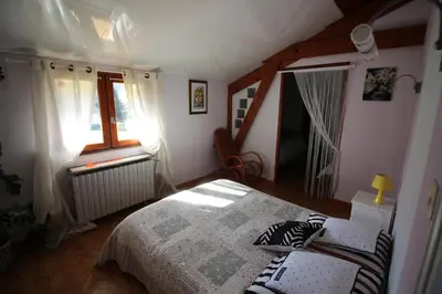 a bedroom with a bed with two pillows on it at la Chaumine aux étoiles in Camurac