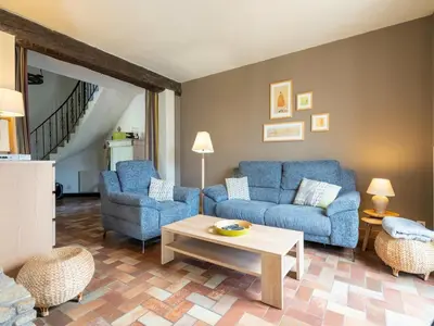 a living room with two blue couches and a table at Lovely country house with private pool in Vieussan