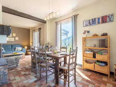 a dining room with a table and chairs at Lovely country house with private pool in Vieussan