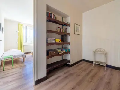 a room with a book shelf with books at Lovely country house with private pool in Vieussan