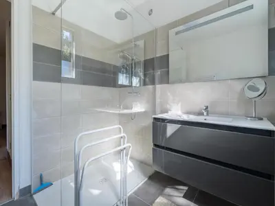 a bathroom with a sink and a mirror at Lovely country house with private pool in Vieussan