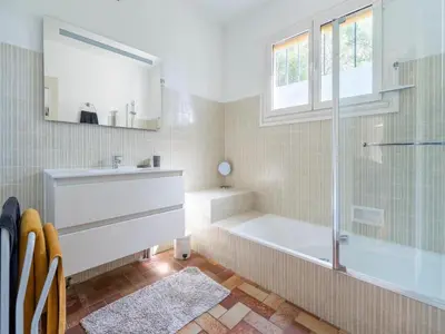 a bathroom with a tub and a sink and a shower at Lovely country house with private pool in Vieussan