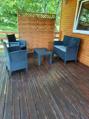 two chairs and a table on a deck at Chalet 2 pers. + Bébé in Montolieu