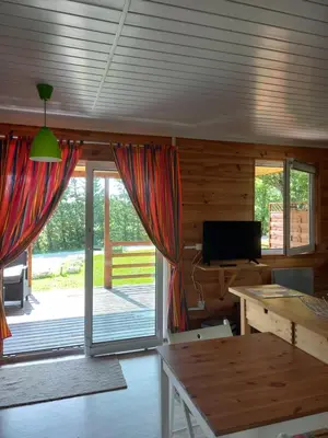 a living room with a large sliding glass door at Chalet 2 pers. + Bébé in Montolieu