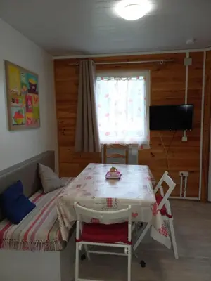 a room with a bed and a table with at Chalet 4 personnes in Montolieu