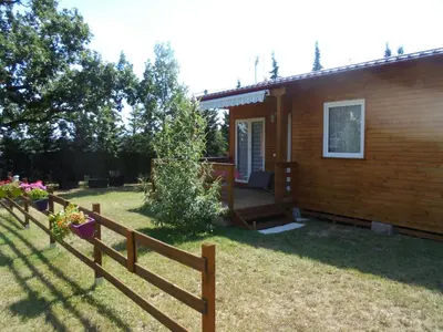 a wooden fence in front of a house at Chalet 4 personnes in Montolieu