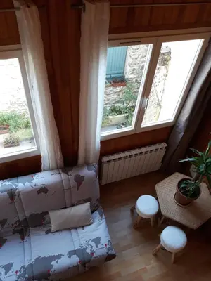 a bedroom with two windows and a bed and a table at ETAPE DE ST COUAT in Saint-Couat-dʼAude