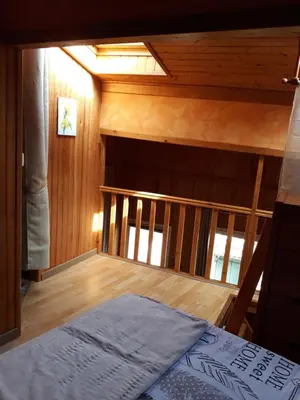 a room with a bed and a wooden floor at ETAPE DE ST COUAT in Saint-Couat-dʼAude