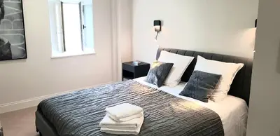 a bedroom with a large white bed with two pillows at Loft Chic in Carcassonne