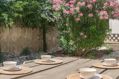 a wooden table with straw hats and cups on it at TRIBUS-GITES URBAINS CARCASSONNE in Carcassonne