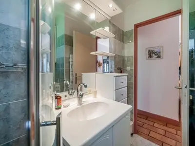 a bathroom with a white sink and a shower at Villa w Garden & Guest House in Prades-sur-Vernazobre