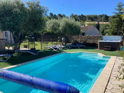 a swimming pool in a yard with a blue pool noodle in the yard at Montbrun Vineyard Escape in Montbrun-des-Corbières