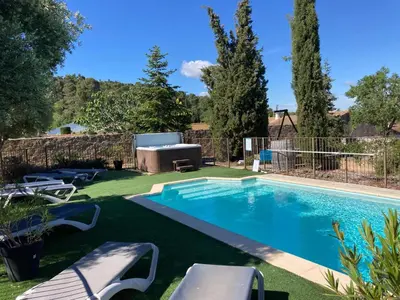 a swimming pool in a yard with chairs and a fence at Montbrun Vineyard Escape in Montbrun-des-Corbières
