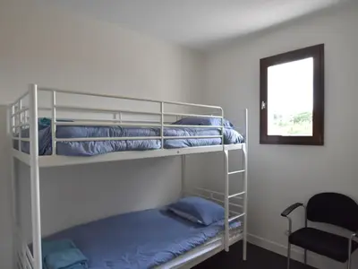 two bunk beds in a room with a mirror at Villa with heated pool, jacuzzi, sports field and stunning views in Montbrun-des-Corbières