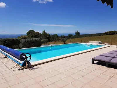 a large swimming pool with a blue pool at Villa Retreat with Pool and pets in Vélieux