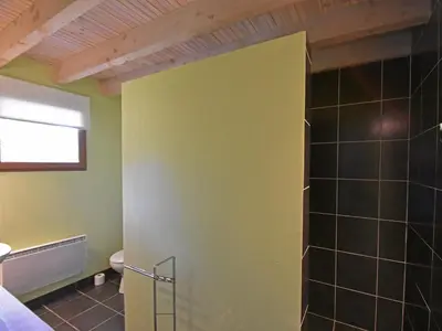 a bathroom with a yellow door in a room at Villa Retreat with Pool and pets in Vélieux