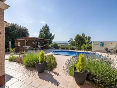 a swimming pool in a garden with plants at Villa in Escales with Private Pool in Escales