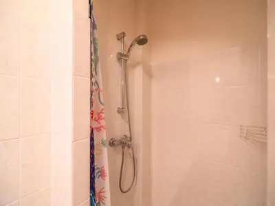a shower with a shower head in a bathroom at Villa in Escales with Private Pool in Escales