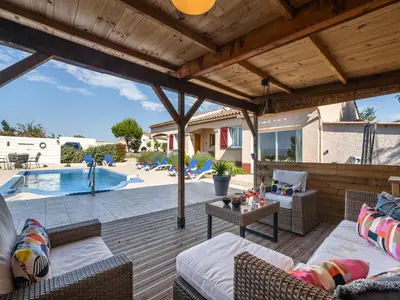 a patio with chairs and a table next to a pool at Villa in Escales with Private Pool in Escales