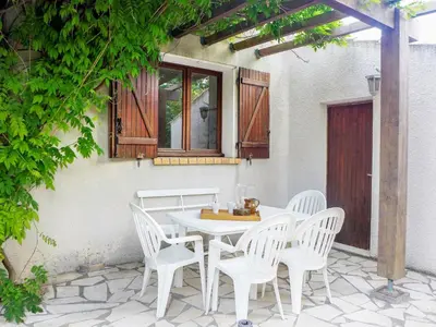 a white table and chairs on a patio at Holiday Home Les Hauts de Grimmal by Interhome in Salles-dʼAude