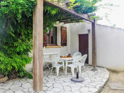 a patio with a table and chairs under a pergola at Holiday Home Les Hauts de Grimmal by Interhome in Salles-dʼAude