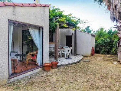 a patio of a house with a table and chairs at Holiday Home Les Hauts de Grimmal by Interhome in Salles-dʼAude