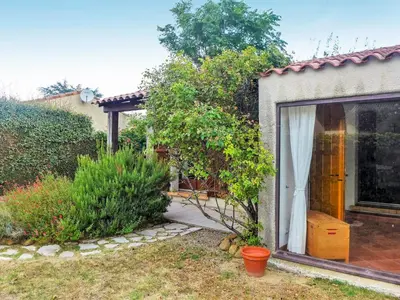 a house with a window and a garden at Holiday Home Les Hauts de Grimmal by Interhome in Salles-dʼAude
