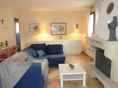 a living room with a blue couch and a fireplace at Holiday Home Les Hauts de Grimmal by Interhome in Salles-dʼAude