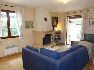 a living room with a blue couch and a fireplace at Holiday Home Les Hauts de Grimmal by Interhome in Salles-dʼAude