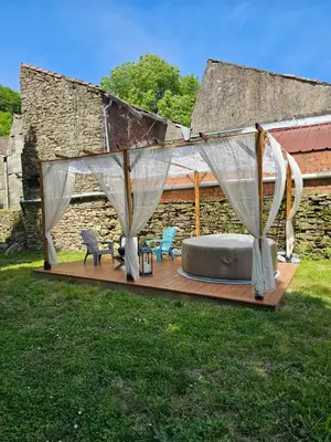 a tent with chairs and a mattress on a deck at Bastide du Thoré in Labastide-Rouairoux