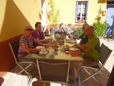 a group of people sitting around a table at L'Art de Vivre in Latour-de-France