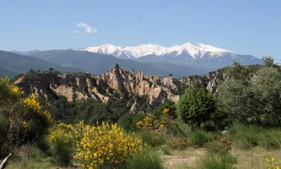 a mountain range with snow capped mountains in the background at L'Art de Vivre in Latour-de-France