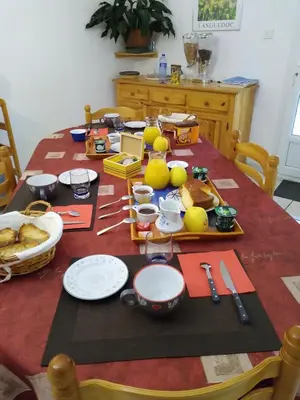 a table with a table cloth with food on it at Les lavandes in Duilhac