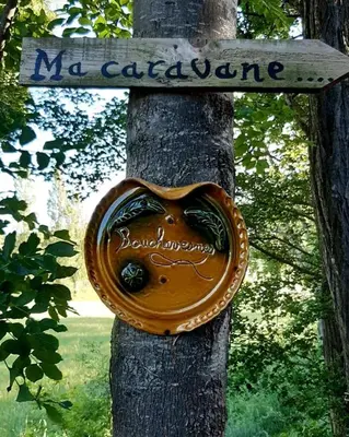 a heart shaped sign attached to a tree at Ma caravane dans les collines in Villeneuve-la-Comptal