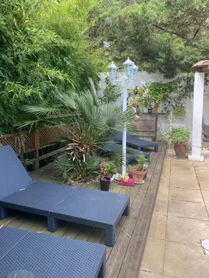 a row of blue benches sitting on a patio at Bed & Breakfast Le Beauséjour in Carcassonne