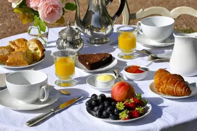 a table with a breakfast of croissants bread and fruit at La Belle Vie B&B in Montréal