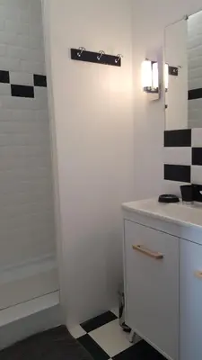 a bathroom with a white sink and a mirror at La Belle Vie B&B in Montréal