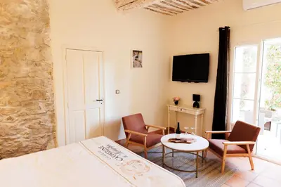 a dining room with tables and chairs and windows at Château Catherine de Montgolfier - B&B et Gites - Piscine - Domaine viticole bio avec dégustation in Narbonne