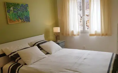 a bed with white sheets and pillows in a bedroom at La villa marquesa in Fitou