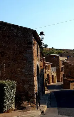an old brick building with a street light on it at La villa marquesa in Fitou