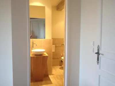 a bathroom with a sink and a toilet at Chambres d'Hotes Domaine de la Capelle in Saint-Martin-Lalande