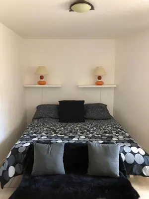 a bedroom with a bed with two lamps on the wall at VVA in Conques-sur-Orbiel
