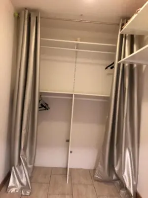 a closet with gray curtains in a room at VVA in Conques-sur-Orbiel