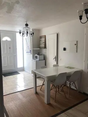 a dining room with a white table and chairs at VVA in Conques-sur-Orbiel